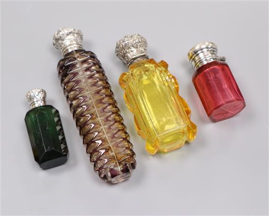 Four assorted late Victorian silver or white metal mounted coloured glass scent bottle including two by C.C. May & Sons,